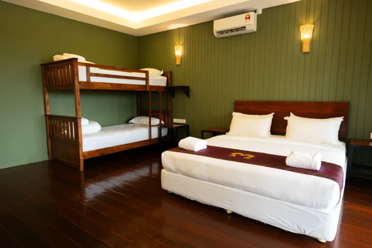 Family River Chalet with king bed and bunk beds at Hornbill Lodge