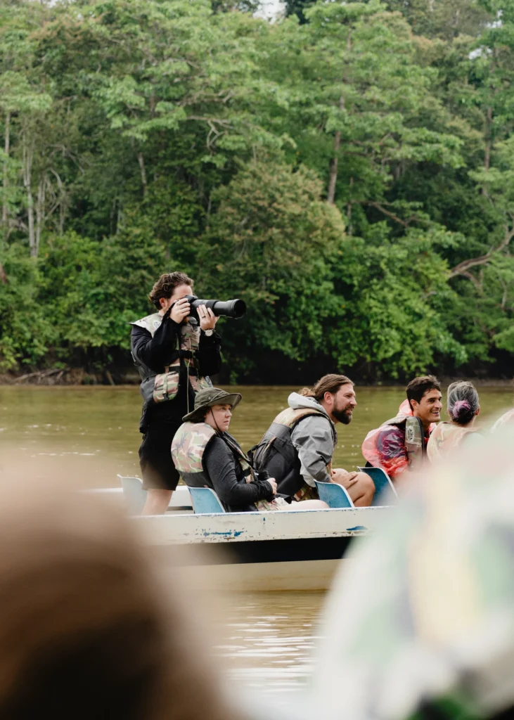 Guests on a Kinabatangan River cruise at sunset